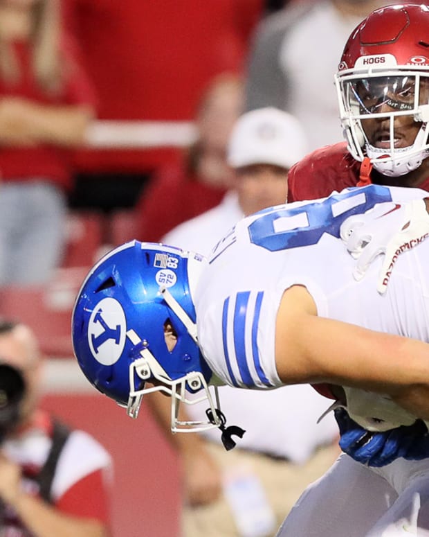 Razorbacks Alfahiym Walcott drags down BYU's Parker Kingston after another completion